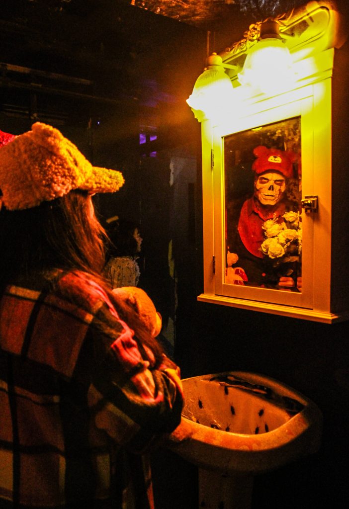 Priscilla Croft sees Jack Twists reflection in a bug-infested bathroom. (Photo by Luisa Loi)