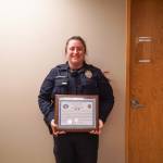 Officer Claire Herrera displays the life saving award, which she received on Monday from the Oak Harbor Police Department. (Photo by Sam Fletcher)