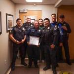 Members of the Oak Harbor police department show support to Officer Claire Herrera (middle), who earned the life saving award on Monday.