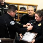 Oak Harbor Police Chief Tony Slowik (left) pins a commendation bar on Officer Claire Herrera's uniform for saving a child's life. (Photo courtesy of the City of Oak Harbor)