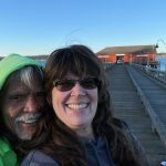 Tony Cladoosby and Michelle Calvin smile in front of the historic Coupeville Wharf, home to their newest coffee shop location. (Photo by Michelle Calvin)