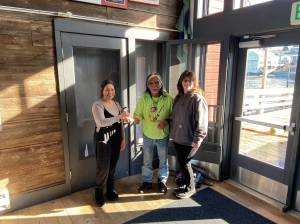 Photo provided
Tony Cladoosby and Michelle Calvin receive the key to their business, Beaver Tales Coffee, located at the Coupeville Historic Wharf.