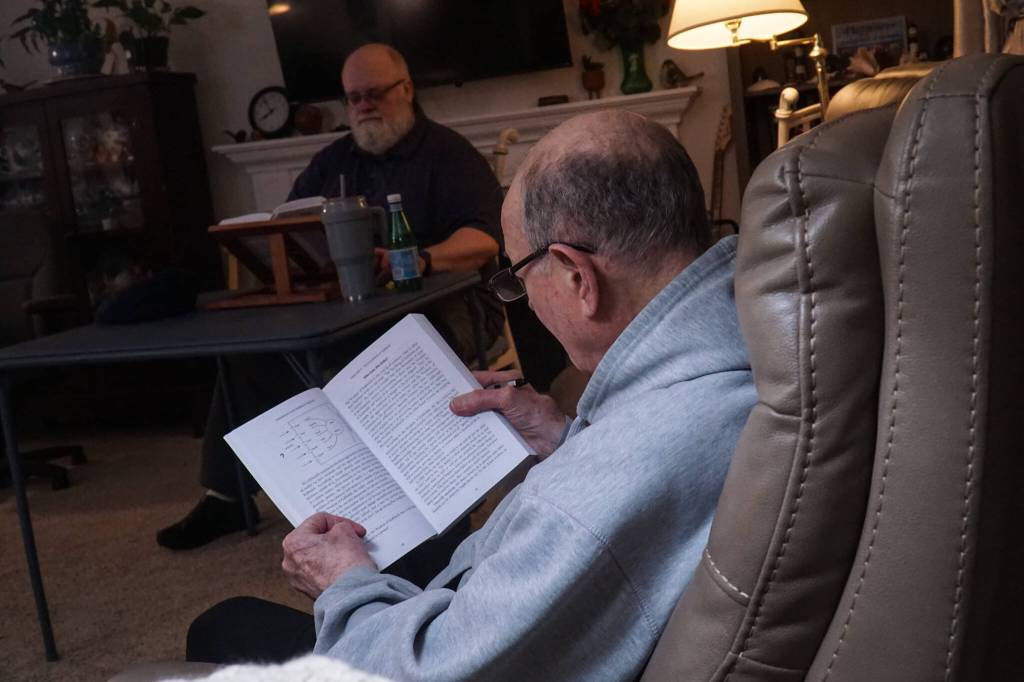 Oak Harbor resident Carl Smith reads at a Kabbalah study session. (Photo by Sam Fletcher)