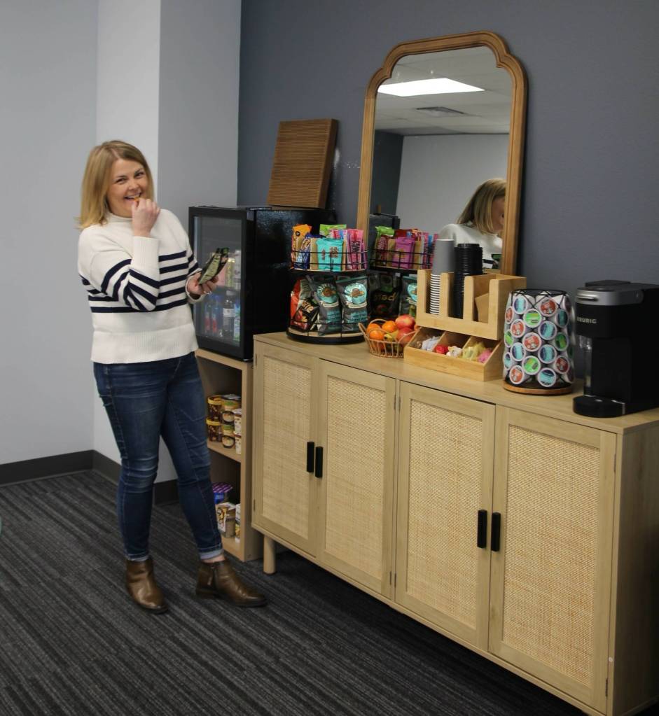 McCullough grabs a snack from the pantry at the Collective. (Photo by Luisa Loi)