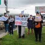 As people held signs and flags in support of trans youths, many drivers honked their cars or revved their engines. (Photo by Luisa Loi)