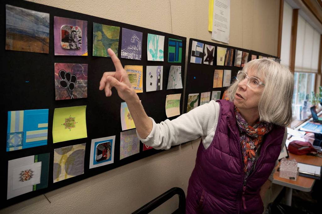 Artist Karen Rothboeck points to a piece displayed as part of Little Art, a new installation in the Freeland Library. (Photo by David Welton)