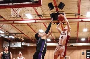 Photo by John Fisken
The difference between a First Team and Second Team All-Conference pick? Chase Anderson made the shot, and Chris Gustafson just missed on the block.