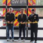 Rep. Dave Paul, Rep. Clyde Shavers and Capt. Eric Hanks from Naval Air Station Whidbey Island cut the ribbon at the new fire station. (Photo by Luisa Loi)