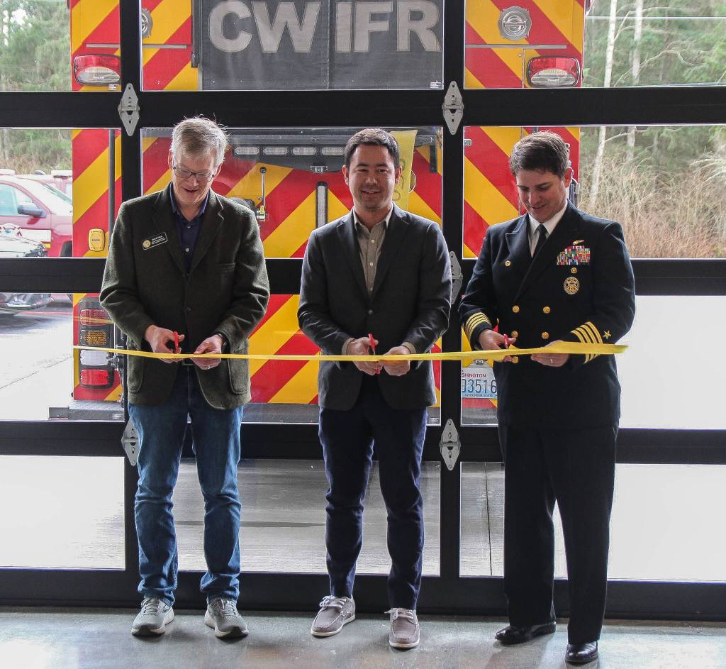 Rep. Dave Paul, Rep. Clyde Shavers and Capt. Eric Hanks from Naval Air Station Whidbey Island cut the ribbon at the new fire station. (Photo by Luisa Loi)