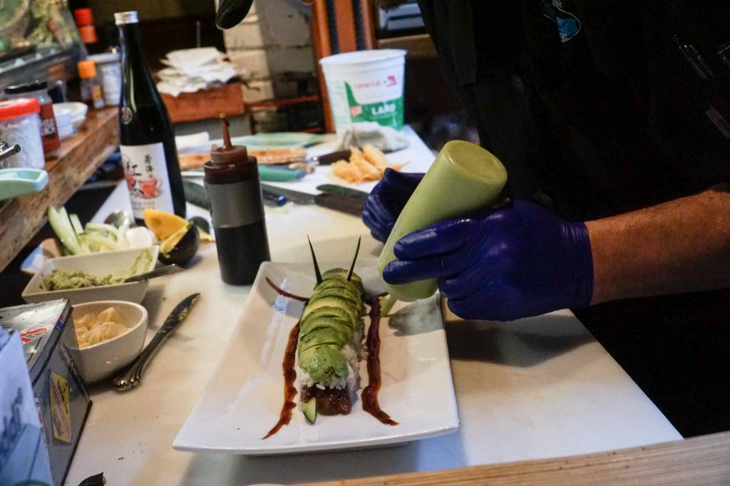 Photo by Sam Fletcher
Sushi chef Claude Johnston prepares the caterpillar roll in Off the Hook.