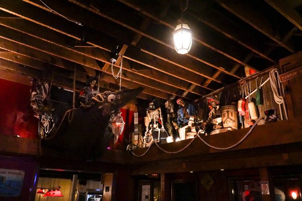 A gang of dead pirates sits below the scaffolding at Off the Hook in Oak Harbor. (Photo by Sam Fletcher)