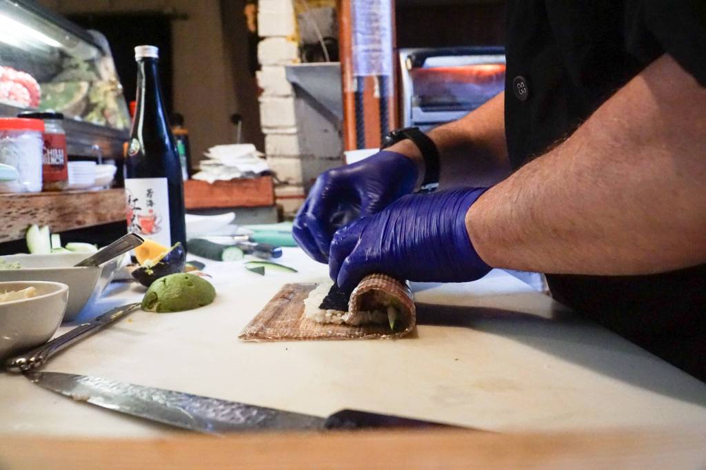 Photo by Sam Fletcher
Sushi chef Claude Johnston prepares the caterpillar roll in Off the Hook.