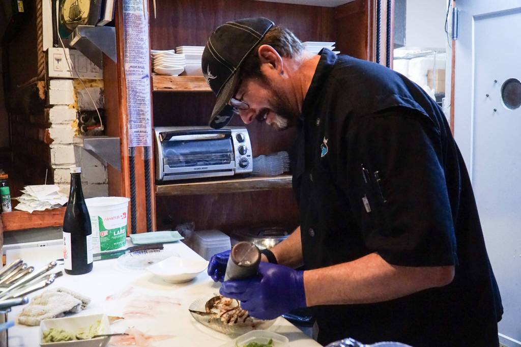Sushi chef Claude Johnston prepares the caterpillar roll in Off the Hook. (Photo by Sam Fletcher)