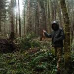 Whidney Camano Land Trust stewardship specialist Kyle Ostermick-Durkey gestures toward a thinned portion of the Trillium Community Forest on Tuesday. (Photo by Sam Fletcher)