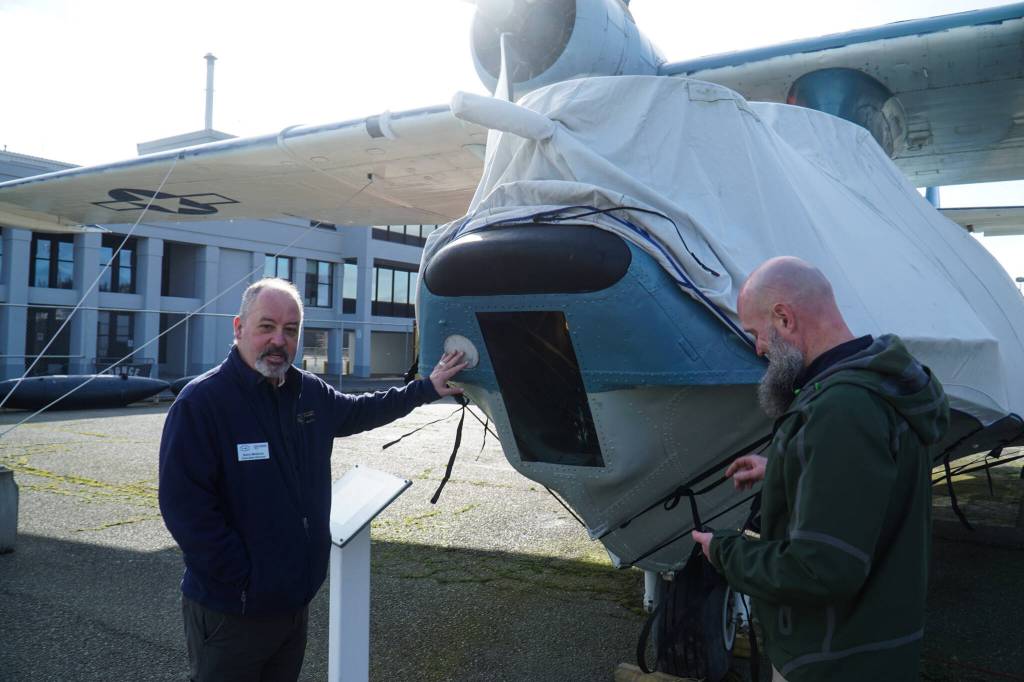 Photo by Sam Fletcher
PNW Naval Air Museum Executive Director Barry Meldrum, at left, and Andrew Cummings, PNW Naval Air Museum aircraft conservation and restoration lead, reveal the PBYs fuselage.