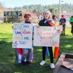 Photo by Luisa Loi
Aryn States, at left, and Leilani Floyd pose with signs at the walkout in honor of Nex Benedict. The two South Whidbey High School students organized the protest on March 18 to demand a safer environment for LGBTQ+ people.