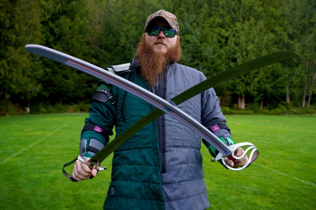 Jeremy Coleman of the Snohomish Dueling Society shows off his swords. (Photo by David Welton)
