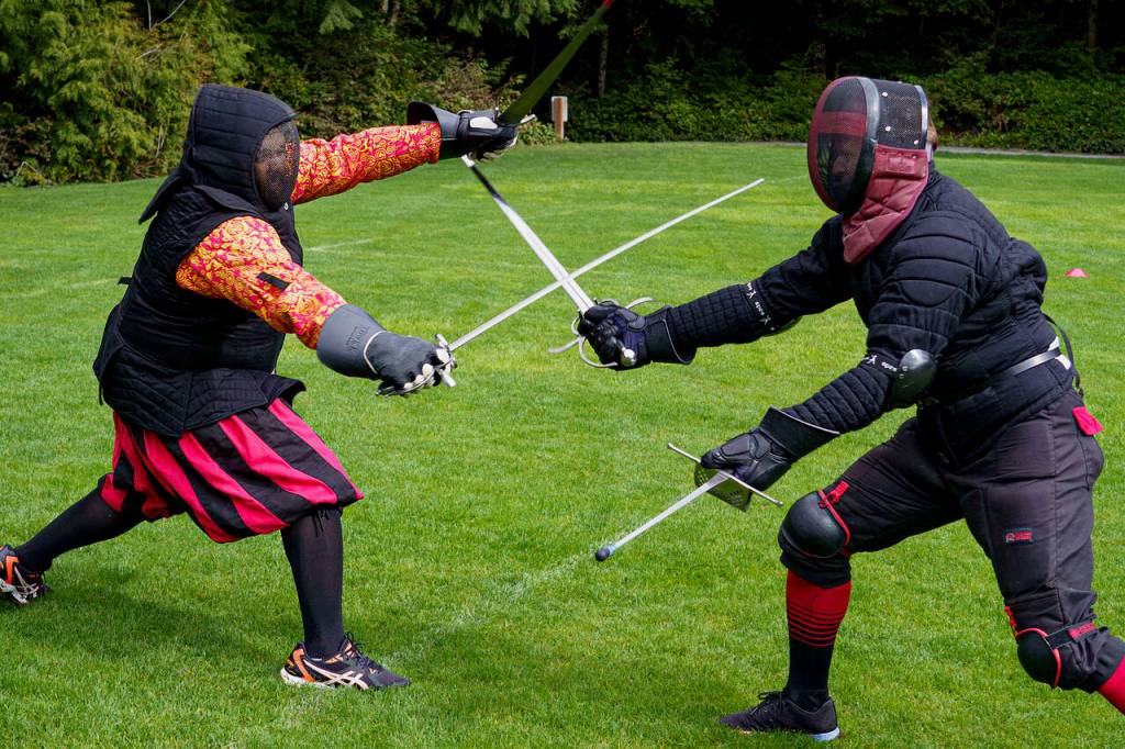 Lorenzo Mendoza, left, duels with Chris Karg. Both men are from the Snohomish Dueling Society. (Photo by David Welton)
