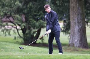 Photo by John Fisken
An Oak Harbor golfer prepares to drive a ball during a golf match at the Everett Invitational March 28 at Legion Memorial Golf Course.