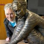 Photo provided
Maria Wickwire poses with the new Anillos, a bronze reproduction of her original ceramic sculpture. The gold lines, inspired by the Japanese tradition known as kintsugi, show where the original piece broke.