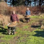 Maria Converse and Gary Ketcheson move old hay to a composting spot at Keystone Farm. (Photo provided)