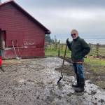 John Cordell takes a moment to appreciate the difference he and his pressure washer made on what was a completely moss- and grass-covered concrete pad. (Photo provided)