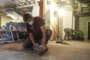 Photo by Sam Fletcher
Ariah Bepler of Kings-Men Construction sands Jumbo Burritos floor to prepare the restaurant to re-open in two weeks.