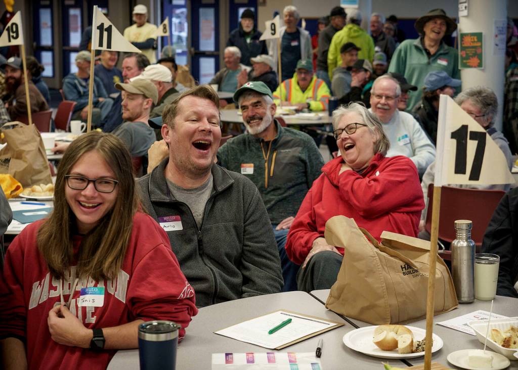 After waking up and laughing at jokes, 308 volunteers head to one of 25 job sites. (Photo by David Welton)