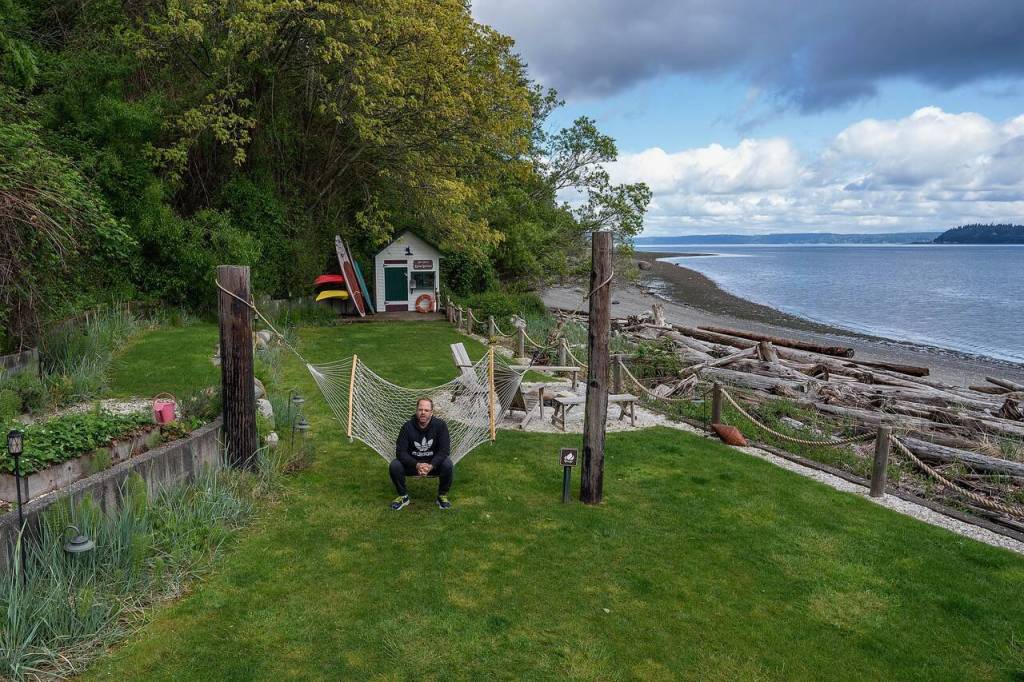Ryan Anderson relaxes on a hammock, enjoying the view of Puget Sound. (Photo by David Welton)