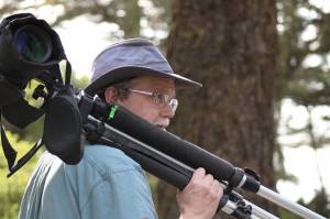 Steven Ellis carries his spotting scope through Ft. Ebey State Park. (Photo provided)