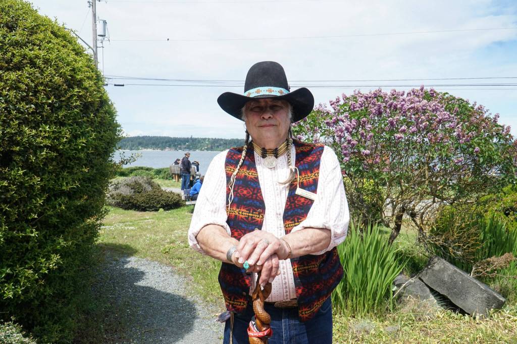 Photo by Sam Fletcher
Storyteller Lou LaBombard stands before the Island County Historical Museum on Saturday.