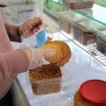 Photo by Luisa Loi
Moira Reed sprinkles Butterfinger pieces on a caramel-dipped cone.
