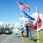 Island County Republican Party President Tim Hazelo (right) rallies with others in Oak Harbor on Thursday. (Photo by Sam Fletcher)