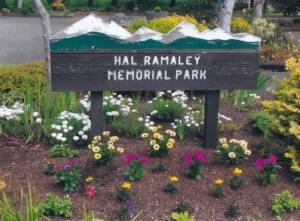A former sign of Hal Ramaley Memorial Park rises above flowers. (Photo provided)