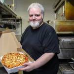 Photo by Luisa Loi
John Youngsman Jr. presents a reporters pepperoni pizza.