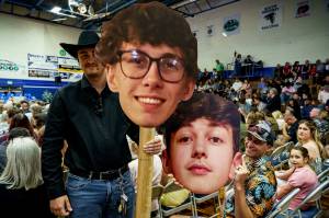 Photo by David Welton
Family members hold signs of Logan Flahertys and Xavier Broyless faces.