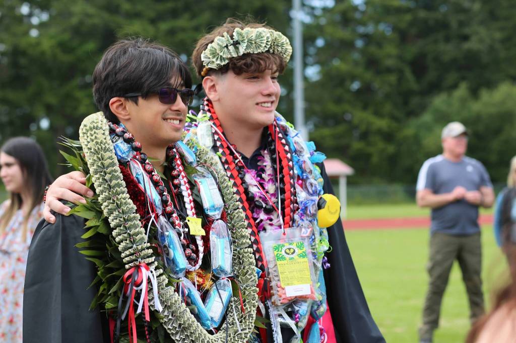 Timothy Nitta, at left, poses with Michael Robinett, who is wearing a crown of cash. (Photo by Bailey)
