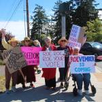 Photo by Luisa Loi
From left, Denise Marion, Anne Woods, Island County Commissioner Melanie Bacon, Liz ODonoghue and Michaline Bruyninckx hold signs.