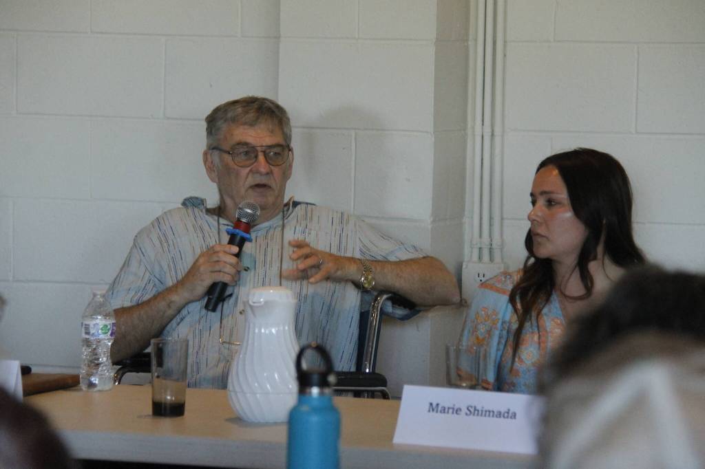 Steven Myres answers a question at the forum while his opponent, Marie Shimada, looks on. (Photo by Kira Erickson/South Whidbey Record)
