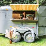 Shaylene Roemer serves a Black Current Lemonade inside the mobile bar, which until three months prior was a horse trailer. (Photo by Luisa Loi)