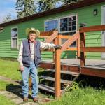 Mr. Hoolie stands next to his longtime Oak Harbor home. (Photo by Luisa Loi)