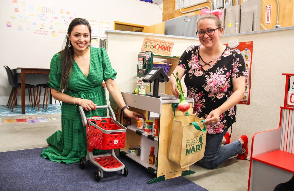 Co-owners Mala Sooknanan and Jaylynn Sybrant have fun pretending to be at the grocery store. (Photo by Luisa Loi)