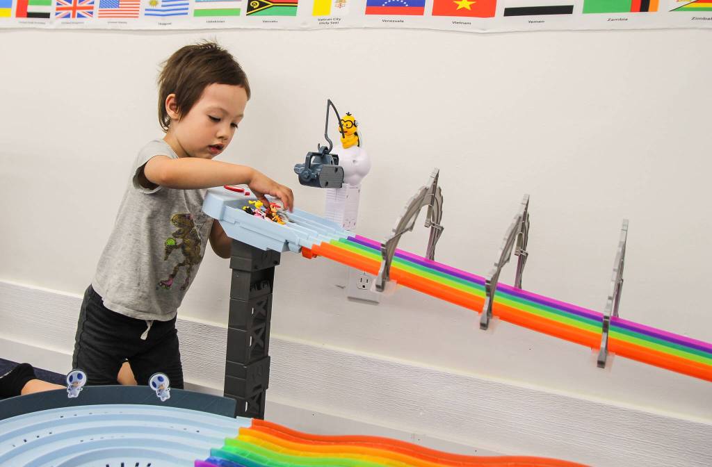Jane Carter plays with a Mario Kart race game in Wheel City, Imagination Coves car corner. (Photo by Luisa Loi)