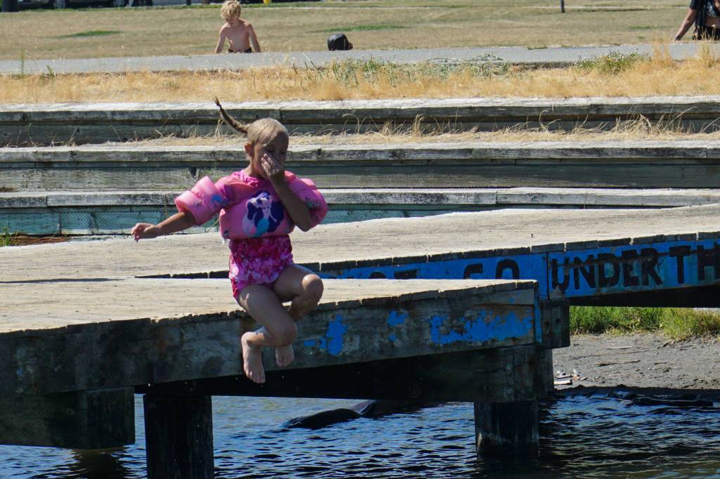 Kenzie Stewart jumps off the dock at the lagoon.