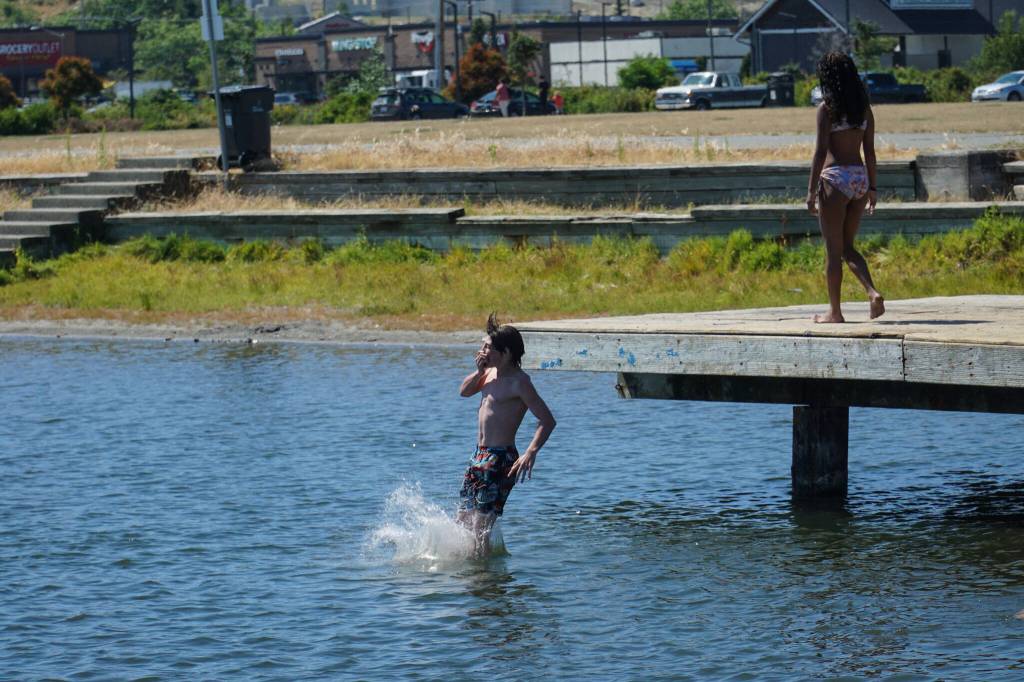 A kid jumps off the dock at the Windjammer Park lagoon. (Photo by Sam Fletcher)