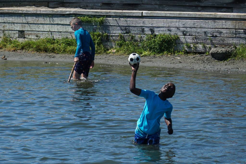 A boy plays fetch at the Windjammer Park lagoon.