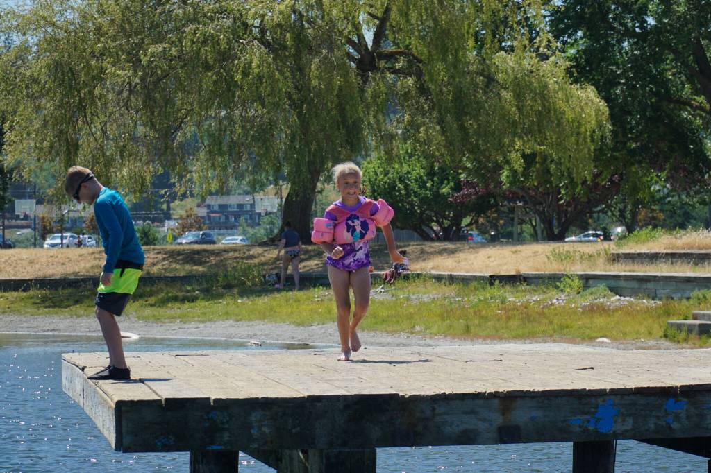 Ava Stewart gets a running start before jumping off the dock at the Windjammer Park lagoon. (Photo by Sam Fletcher)