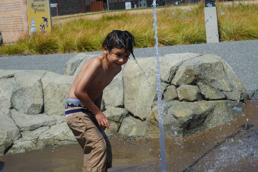 Alex Youngblood plays with a spout at the Splash Park in Oak Harbor. (Photo by Sam Fletcher)