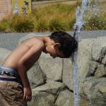 Alex Youngblood plays with a spout at the Splash Park in Oak Harbor. (Photo by Sam Fletcher)