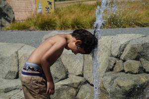 Alex Youngblood plays with a spout at the Splash Park in Oak Harbor. (Photo by Sam Fletcher)